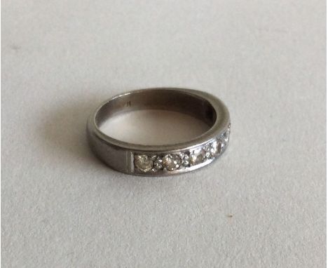 A heavy platinum and diamond half eternity ring. Approx. 4 grams. Est. £80 - £120.