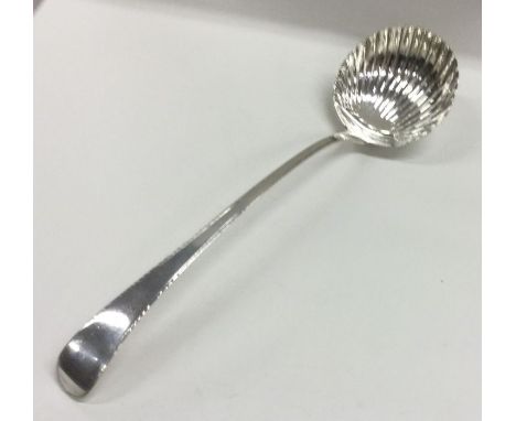 A large George III silver fluted soup ladle with feather edged rim. London 1783. By James Sutton. Approx. 149 grams. Est. £10
