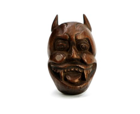 A character trope in Noh theatre, this netsuke  depicts a 'Hannya' mask – typically representing a  scorned woman turned into