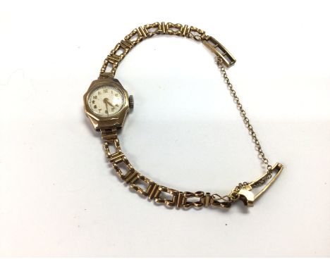 A vintage ladies 9ct gold watch and strap. 13.1g