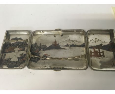 A silver cigarette case together with a silver plated Japanese cigarette case .