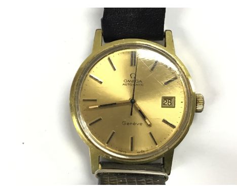 A vintage gents Omega automatic watch. 36mm case with champagne dial. Leather strap. Winds and run.