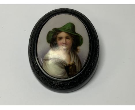 A porcelain and phenolic vintage brooch. (A) NO RESERVE