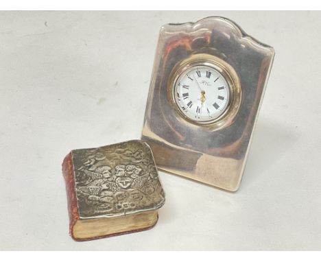 A silver clock and silver fronted bible , postage category B