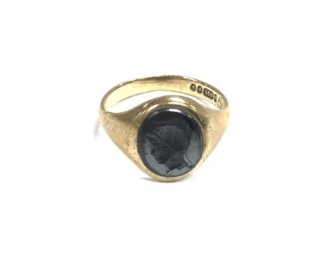 A 9ct gents Haematite centurion head signet ring. 4.2g and Size R