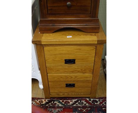 A good quality modern light oak bedside cabinet with two drawers.