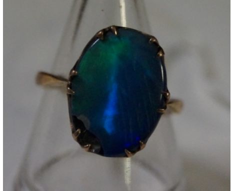 A 9ct gold and opal ringA.f., with blue and green colour, weight 3g 