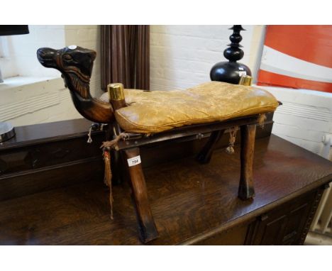 A Vintage carved hardwood camel stool with leather seat.