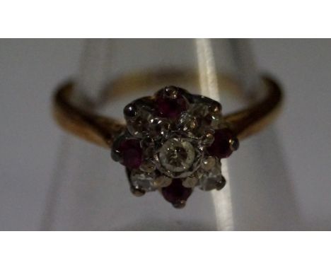 A ruby and diamond cluster ring, to an 18ct gold shank, weight 3g