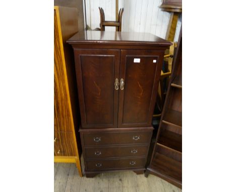 A reproduction mahogany cocktail cabinet with interior mirror and light, two shelves and drawer enclosed by three cupboard do