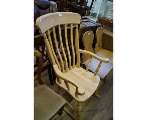 A stripped and varnished light fruitwood rocking Windsor armchair.