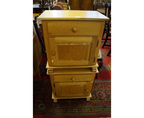 A pair of light oak bedside cabinets.