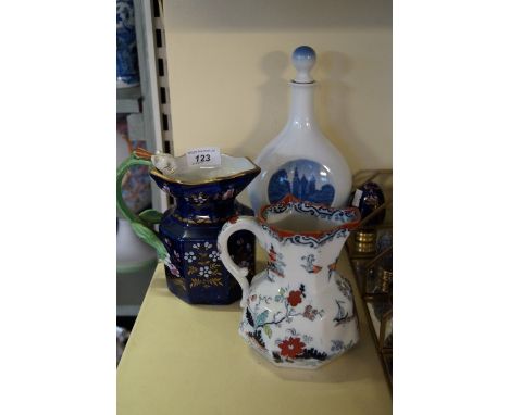 A Royal Copenhagen blue and white flask, together with two 19th century Masons ironstone jugs 