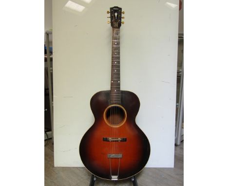 An early 20th Century acoustic guitar in the L3 form, the headstock with mother of pearl inlaid Gibson lettering over a 19 fr