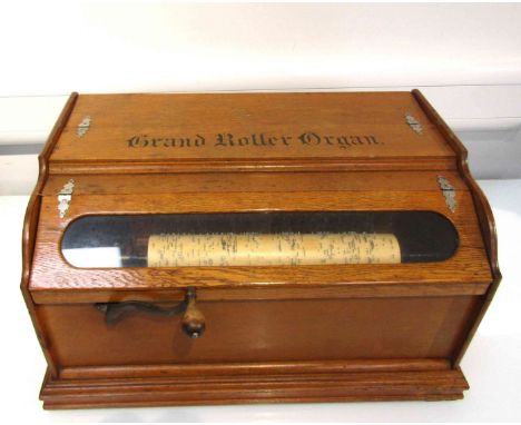A Grand Roller Organ 32 key action, by the Autophone USA Company in light oak case, with eight rollers of various ages. Cylin