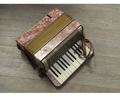 An Estrella-Jubilee 12 bass piano accordion, hard cased with music books 