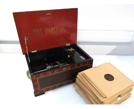 An Imperial disc player, single comb music box in a grained rosewood-effect case with side handles. Case 41.5cm wide. With ke