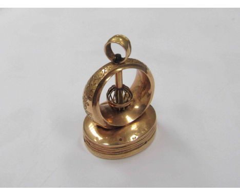 A gold musical seal with barillet movement, engraved bow, playing base. 4cm tall. Slight stress to case