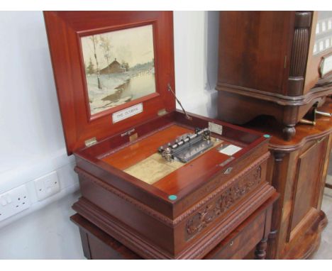 The Olympia in mahogany case, playing 15¾" discs on two combs, on a two drawer base with bobbin-turned legs.  With original a
