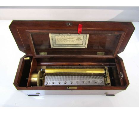 A lever-wind six air single comb music box, un-named, numbered 7926, in inlaid rosewood case with chamfered corners. Cylinder