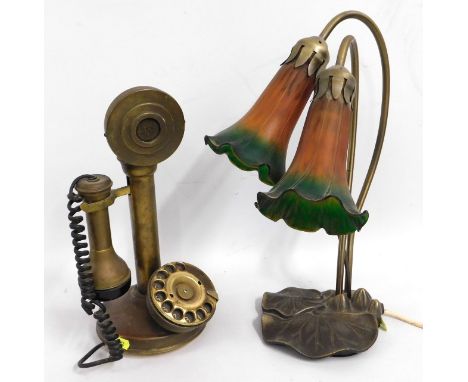 A brass mounted art nouveau styled lamp with glass fluted shades, 15.75in tall, twinned with a brass candlestick telephone
