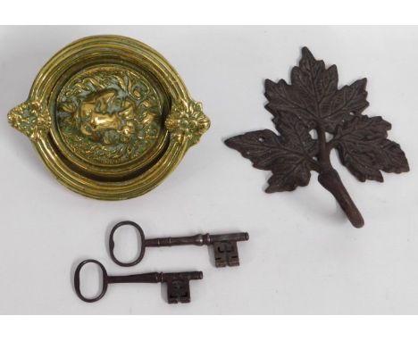 A 19thC. brass lion head door knocker, 5in diameter rear, 6.5in drop knocker, a cast iron leaf coat hook & two 18th/19thC. do