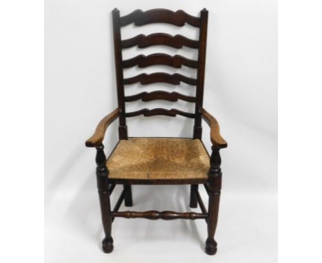 An antique ladder back chair with rush seat, 43.5in high to back