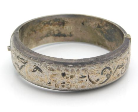 A 1955 Birmingham silver bangle with chased decor by E. Lilley & Co. 58mm diameter, 31.9g