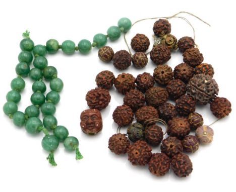 A quantity of 19thC. Chinese jade beads twinned with seven Chinese carved Hedaio beads, a Meiji period Japanese two faced mas