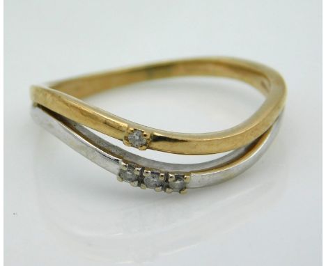 A two colour, 9ct gold double layer ring set with small diamonds, small crack to underside of shank, 2.1g, size R/S