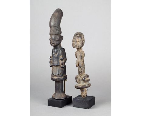 A Yoruba Eshu staff Nigeria wood, the kneeling female figure with her hands on her breasts, 20.5cm high, on a stand, and a la