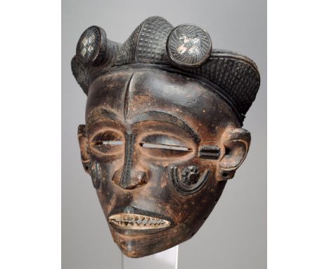 A Chokwe mask Democratic Republic of Congo wood with a tripartite lobed and diced coiffure with two front discs, the face wit
