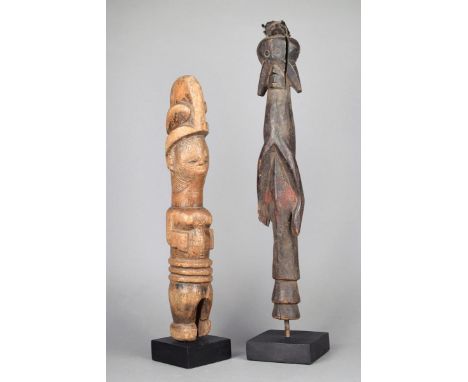 An Igbo standing female figure Nigeria wood with a high crested coiffure, facial and body scarifications, 37.5cm high, on a s