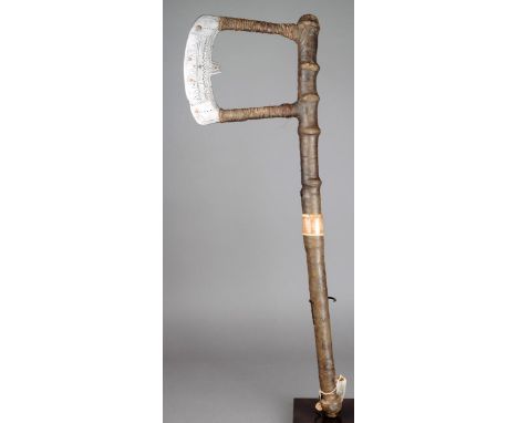 A Worji war axe Bauchi Province, Nigeria with an open curved blade with incised decoration and inlaid copper circles with pla