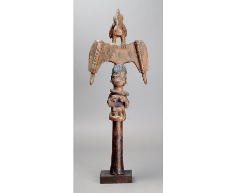 A Yoruba Shango staff Nigeria wood with a kneeling female figure with an integral necklace and remains of Reckitt's blue, wit