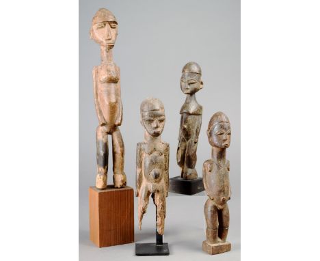 Four Lobi standing figures Burkina Faso wood, 28cm the highest, three on stands. (7) Provenance The David Morris Collection. 
