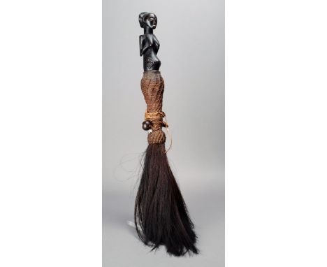 A Hemba fly whisk Democratic Republic of Congo wood, fibre, feather, hair and a seed, with a female half figure finial, the h