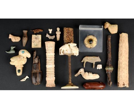 A collection of antiquities including a gilt metal shield boss, two bone handles, two sword handles, one with carved alabaste