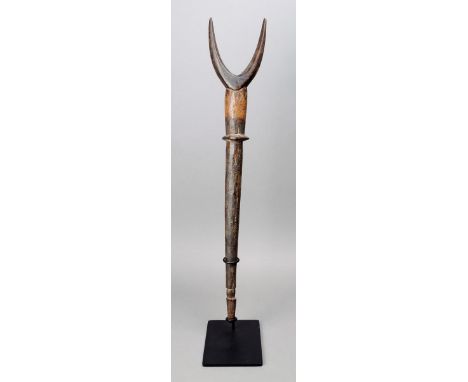 A Lobi flute Burkina Faso wood of tapering form with a twin 'horn' finial and a flattened knop with incised linear decoration
