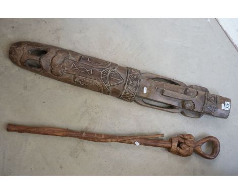 Two carved wooden tribal items to include a large mask and a walking stick with elephant and snake decoration. 