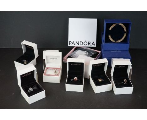 A collection of Pandora silver charms in original gift boxes together with a Swarovski bangle. 