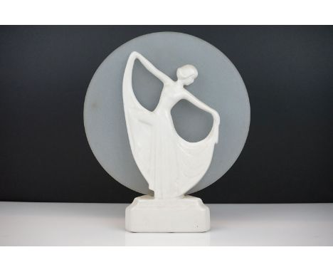 Art Deco White Ceramic Table Lamp in the form of Dancing Lady in front of a frosted glass circular panel, 33cm high 