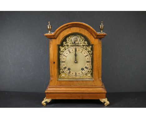 An early 20th century wooden cased chiming bracket clock, brass face with subsidiary dial, decorative brass feet and finials.