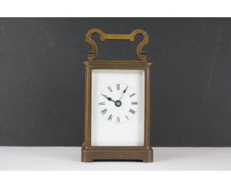 An antique brass cased carriage clock with white enamel dial. 