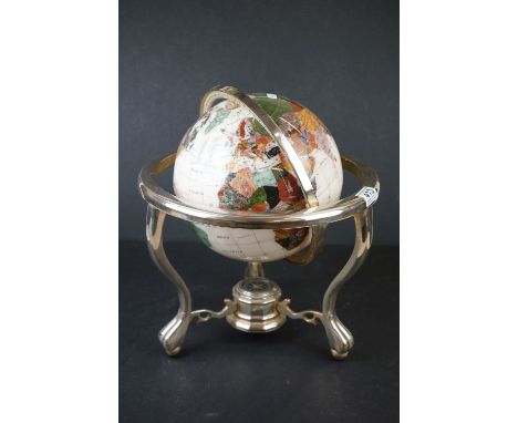 A table top globe made from semi precious stone with compass set to base. 