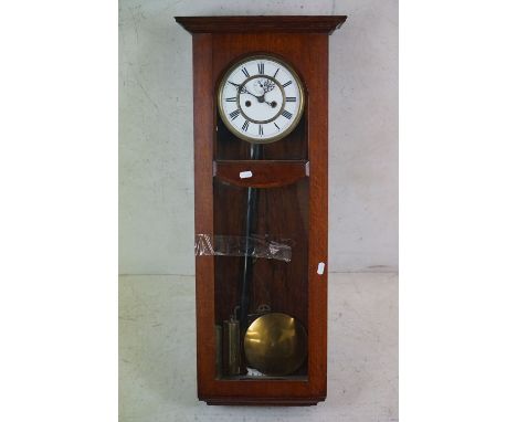 An early to mid 20th century oak cased hanging wall clock. 