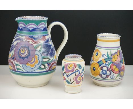 Poole Pottery Jug decorated in the HE Bluebird pattern (handle re-attached) 21cm high together with Two Poole Pottery Vases w