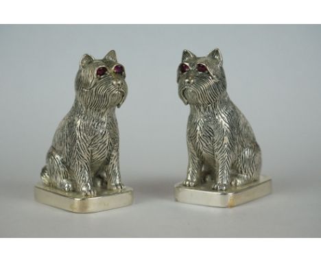 Pair of dog condiments stamped 800, with ruby eyes 