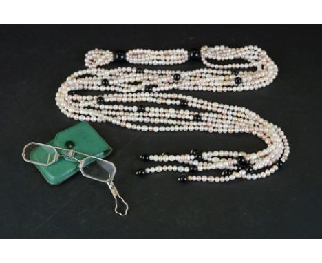 A natural pearl necklace together with a pair of folding Lorgnettes Spectacles. 