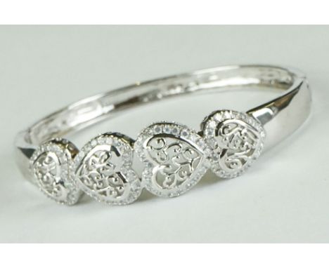 Silver bangle with four open hearts, set with CZ 